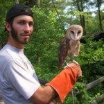 A Camper pose for a picture with a Owl