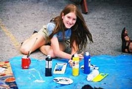 A Camper setting up a mini studio to practice her creative art skills.