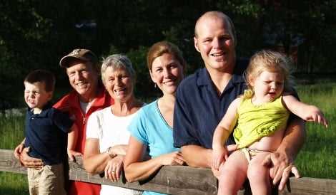 The camp director, Jud and his family posing for a group picture.