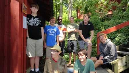 8 male Campers posing for a group picture.