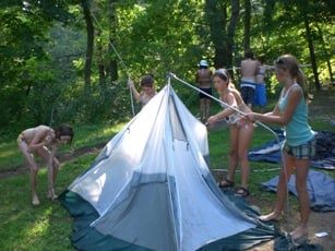 A group of Campers Making Camp Tent
