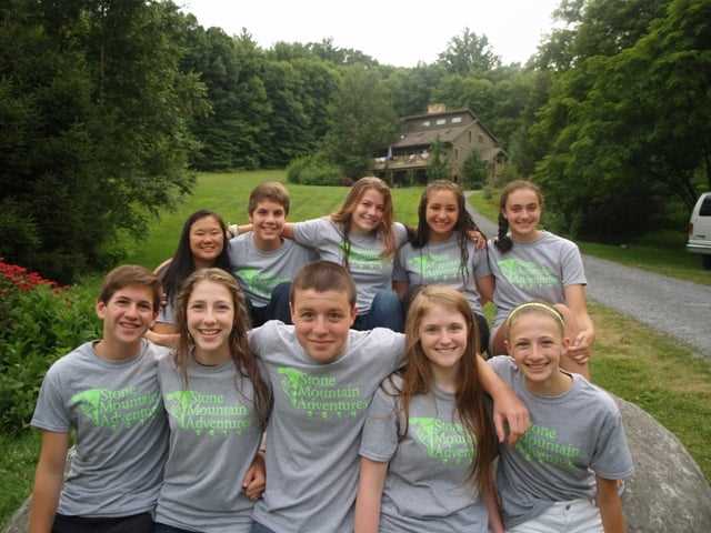 A group of Campers in the camp t-shirt pose for a picture.
