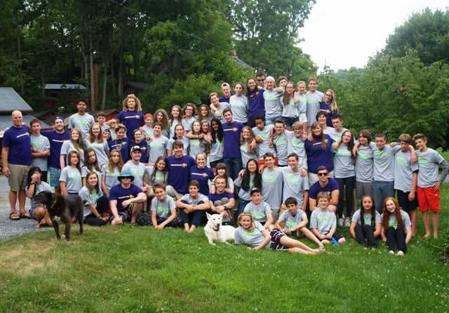 A group of Campers in the camp t-shirt pose for a picture.