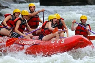 A group  of Campers in a white water rafting session.