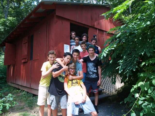 A group of teen male Campers pose for a picture.