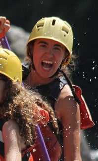 An excited female Camper river rafting.