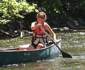 A camp counselor enjoying her boat ride.