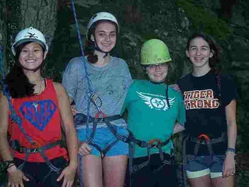 A group of Campers in their rock climbing gear pose for a picture