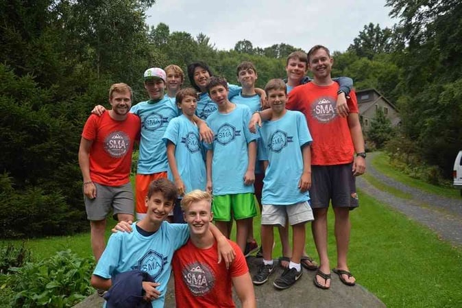 A group of male Campers pose for a group picture in SMA T-shirt