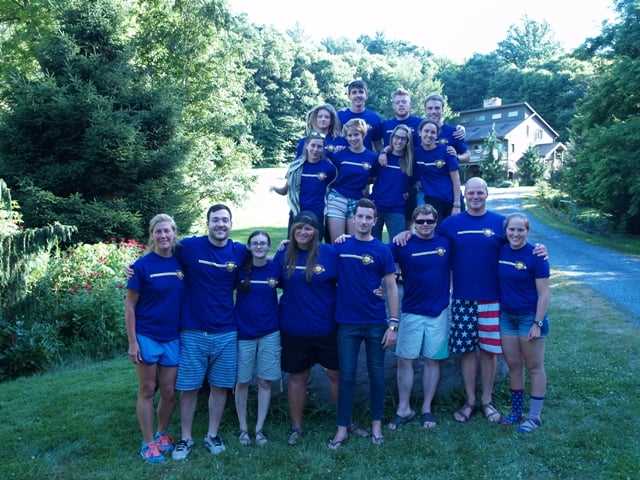 The camp director in a group picture with some teen Campers and the camp staff.