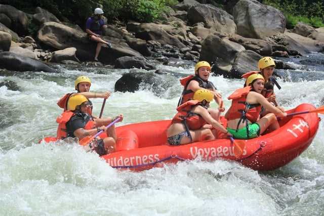 A group of teen Campers in a white water rafting session.