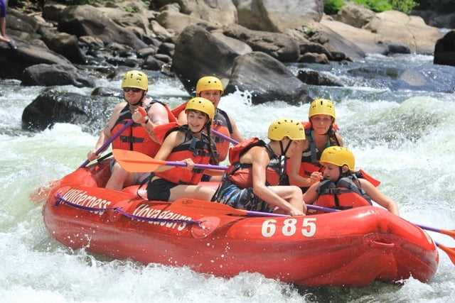 A group of Campers in a white water rafting session.