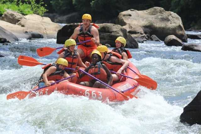 A group of Campers in a white water rafting session.
