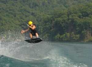 A male Camper wakeboarding,