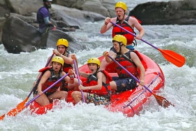 A picture of a safety guard watching SMA Campers as they go about their river rafting activity. 