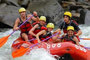 A group of teen Campers in a white water rafting session.