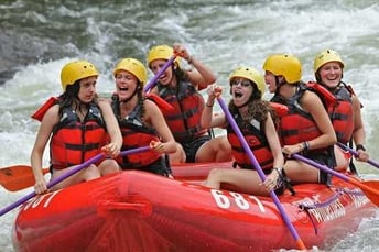 A group of Campers in a white water rafting session.