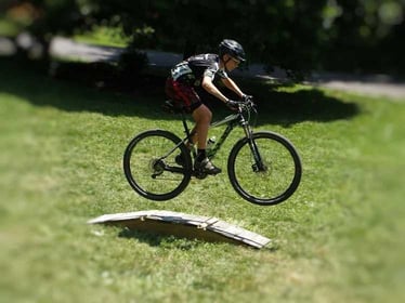 A male Camper riding a bike.