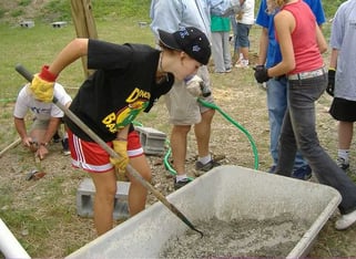 Picture of a male Teen Camper participating in the service project of the camp.