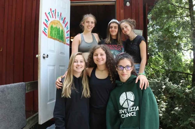 A group of Teen female Campers pose for a picture.