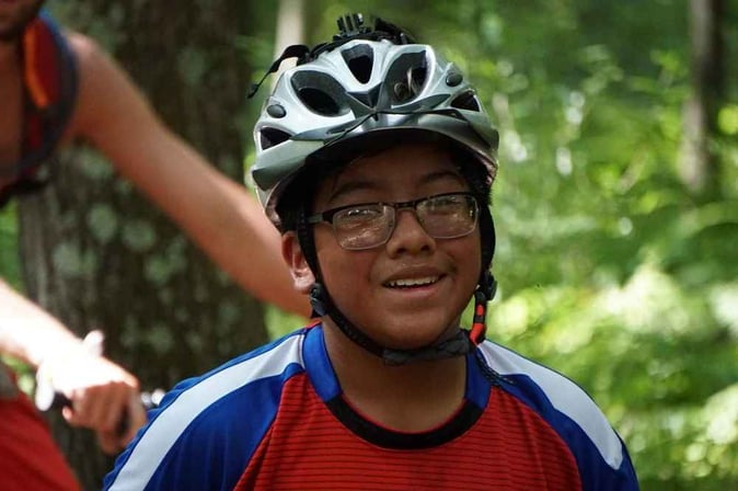 A Teen male biker pose for a picture.