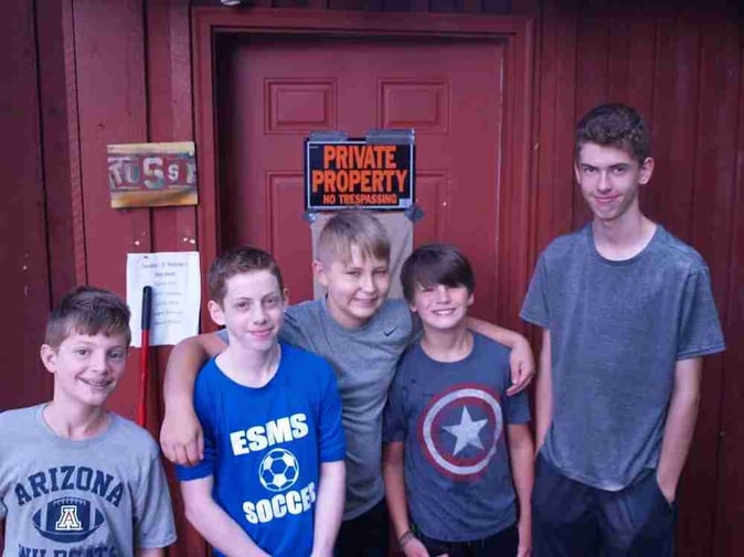 A group of Teen male Campers pose for a picture.
