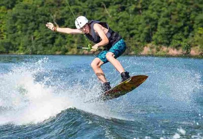 A male Camper wakeboarding