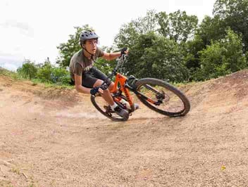 A male Camper riding a bike