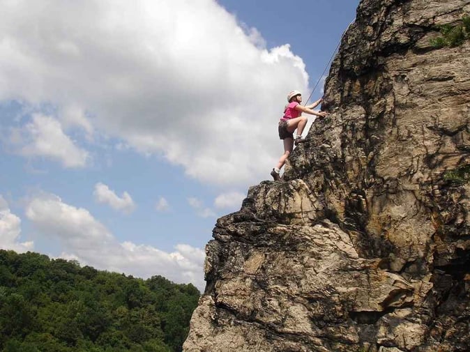 A Teen Camper rock climbing