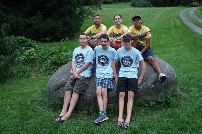 A group of male Campers in SMA T-shirt pose for a picture