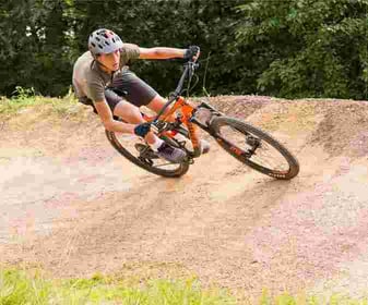 A male Camper riding a bike