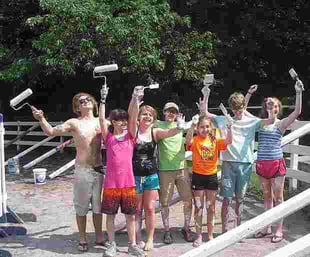 A group of Campers pose for a picture after completing their painting project