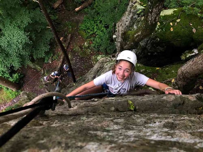 A female Camper Rock Climbing