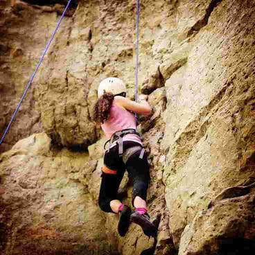 Picture of a female Camper rock climbing
