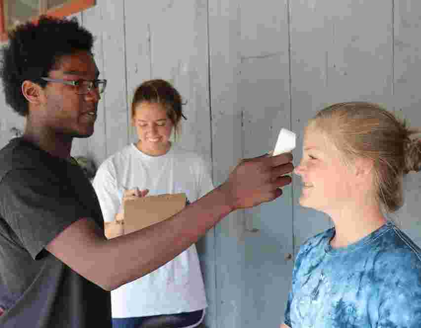 Picture of a female Camper being examined by a member of COVID-19 team.