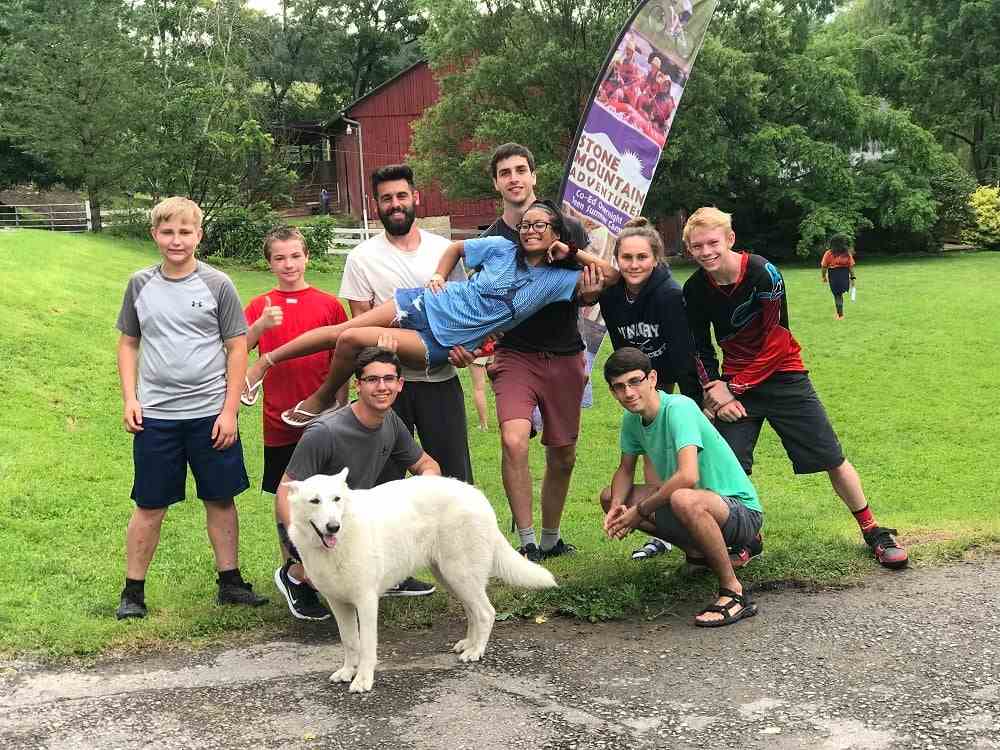A group of Camper and a dog pose for a picture
