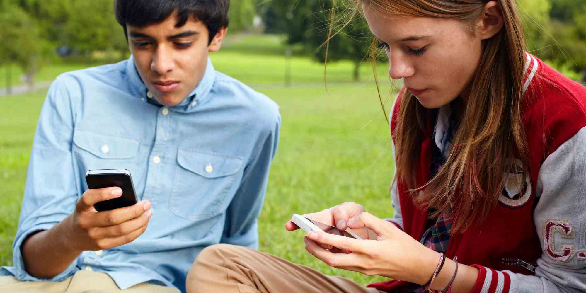 A male and a female Camper pressing their phone.