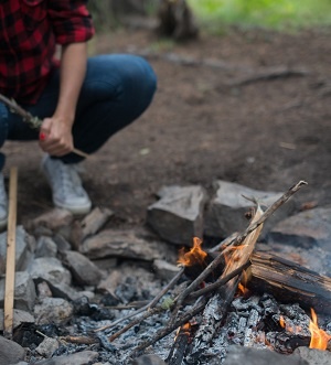 Picture of a Camper making campfire 